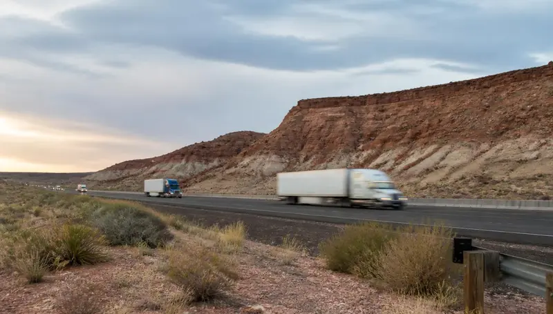 Interstate 15 traffic passing the red bluffs at the Leeds, Utah exit — health insurance and ACA Marketplace enrollment for Leeds, Utah 84746 households