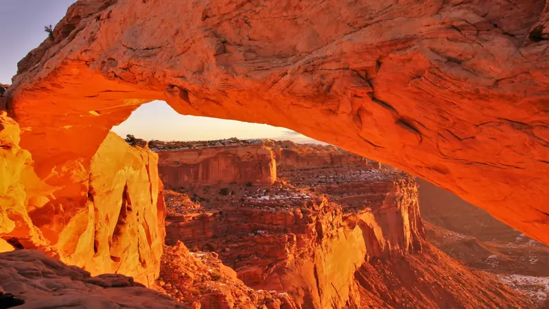 Sunrise light glowing under a red sandstone arch in Utah canyon country — Washington City, Utah ACA health insurance for 84780 families