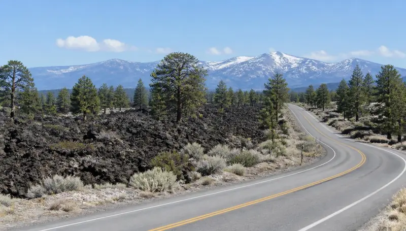 Black lava rock fields and juniper along the highway near Central, Utah — health insurance and ACA Marketplace enrollment for Central, Utah 84722 households