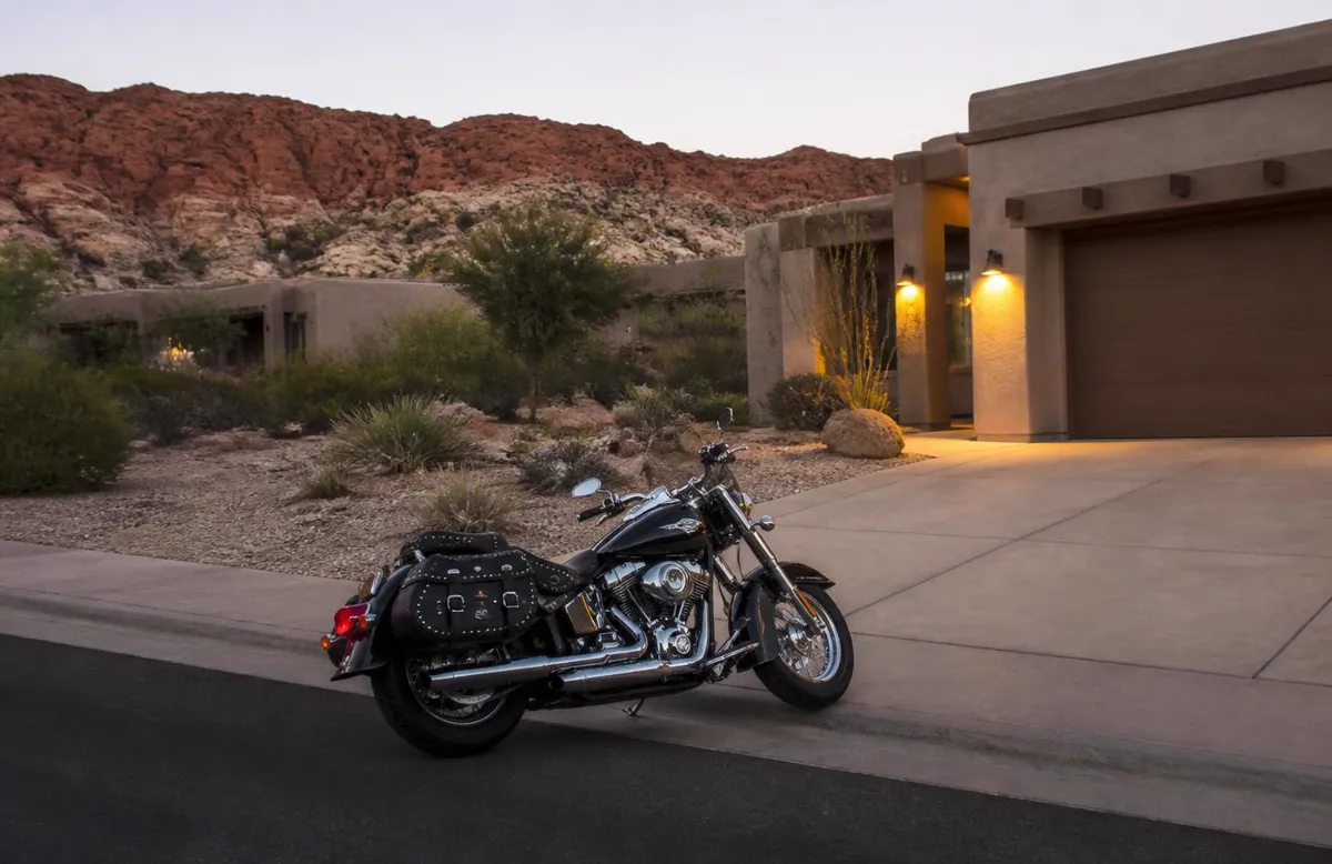 Custom cruiser with chrome exhaust parked in a desert driveway at dusk in Enoch