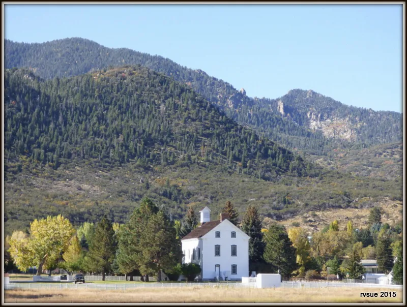 Historic Pine Valley Chapel (1868) with Pine Valley Mountain wilderness behind — the 84781 cabin community OnPoint Insurance Group writes auto and home coverage for