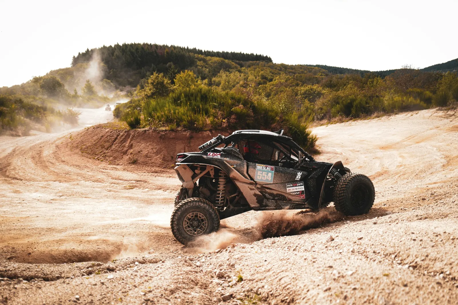 Side-by-side UTV kicking up dust on a Southern Utah trail