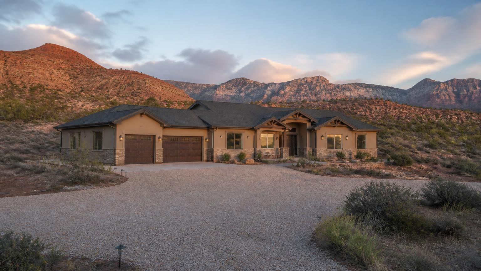 Homeowners insurance in Central, Utah (84722) — a single-family home on SR-18 acreage in Central, Utah with red rock mesas and high-desert sage in the background