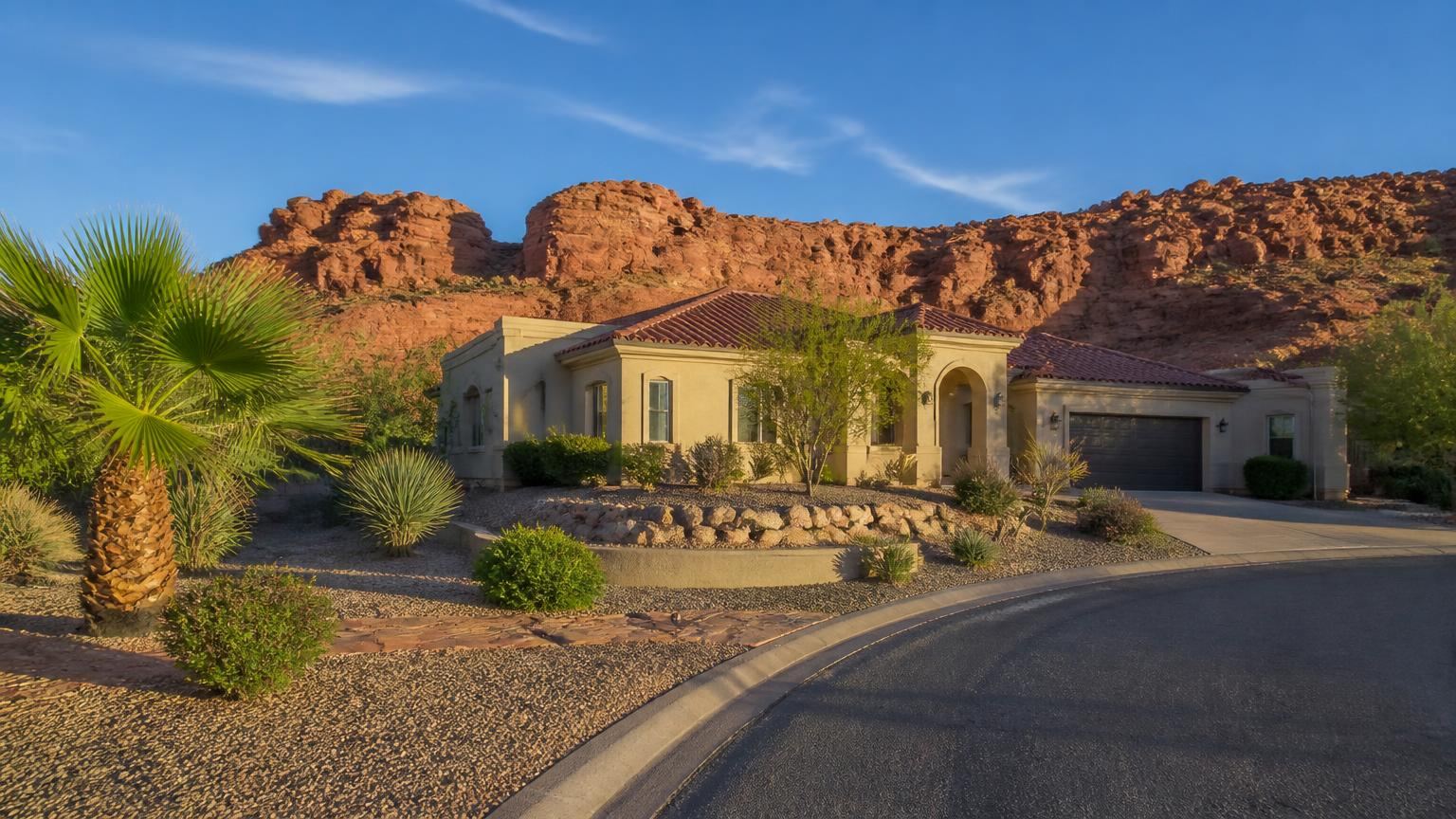 Homeowners insurance in Leeds, Utah (84746) — a stucco tile-roof home in Leeds, Utah below the red Silver Reef sandstone ridges