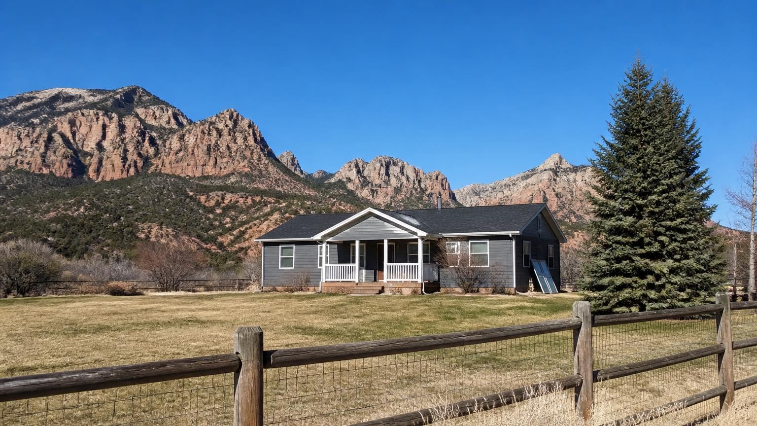 Homeowners insurance in New Harmony, Utah (84757) — a one-acre rural home in New Harmony, Utah with the Kolob Canyons cliffs behind