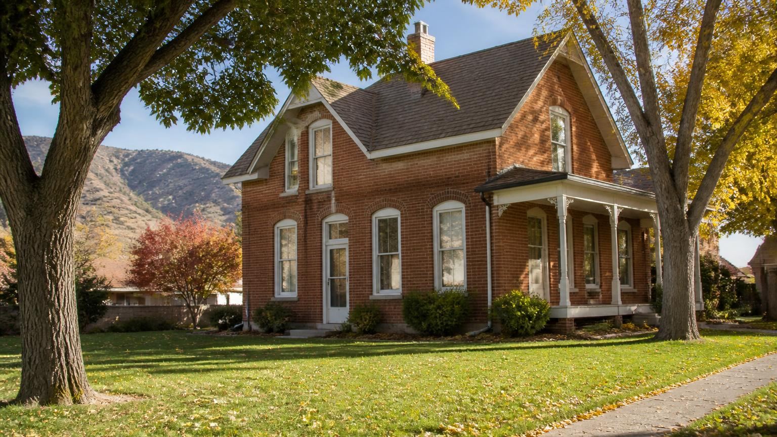 Homeowners insurance in Parowan, Utah (84761) — a historic brick pioneer home on a tree-lined street in downtown Parowan, Utah