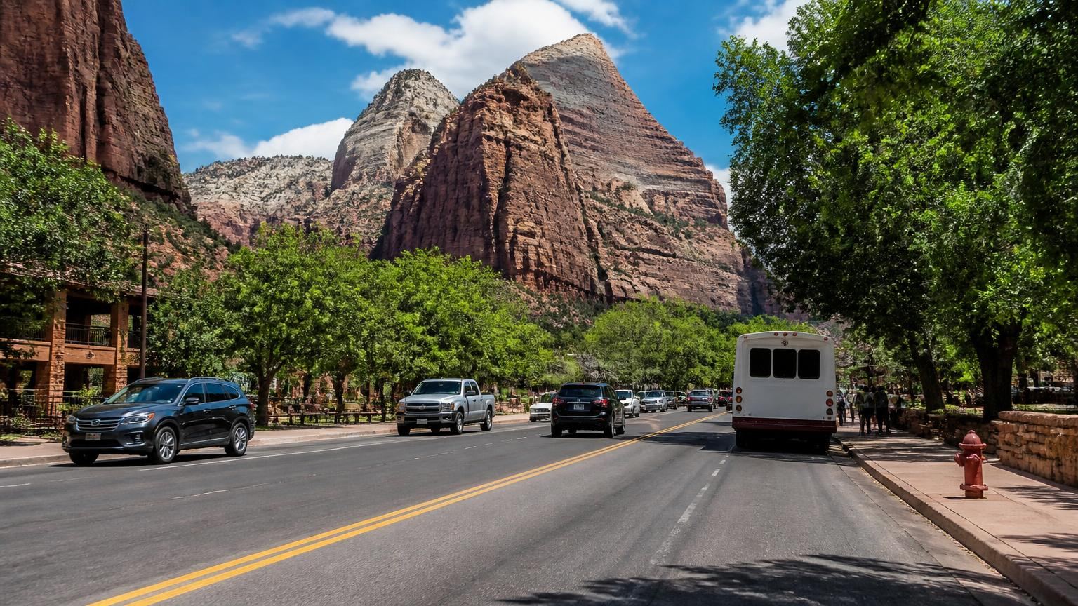 Car insurance in Springdale, Utah (84767) — main street traffic at the mouth of Zion Canyon beneath towering red cliffs
