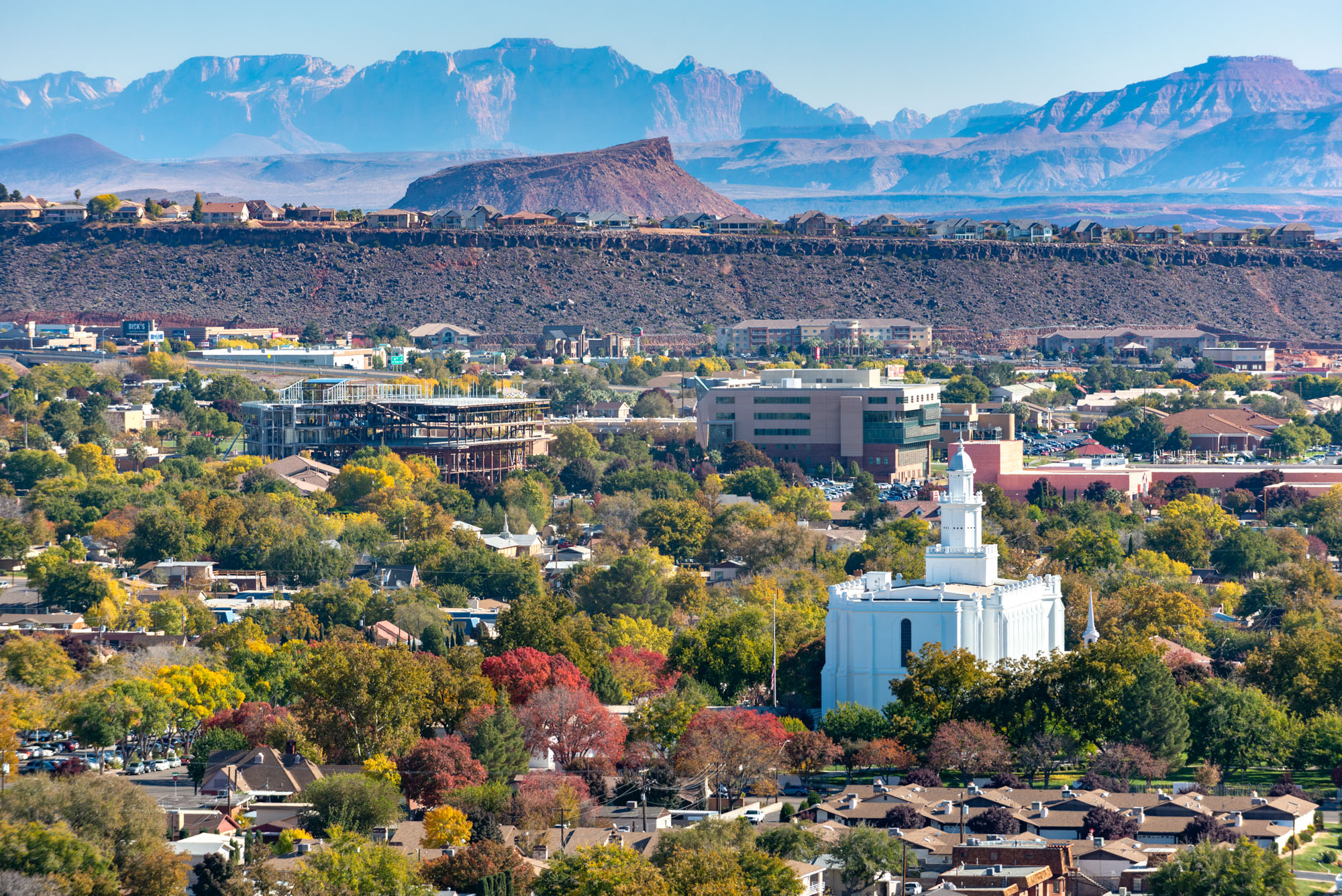 St. George, Utah temple with Zion National Park mountains in the distance